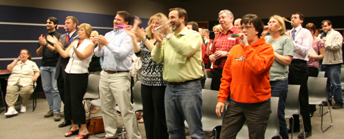 TRU staff members hoot, hollar and rise to their feet as April is announced as the winner of TRU-OL's Grow Your Education, Compete to Complete contest run on Facebook from January 29-April 18, 2010.