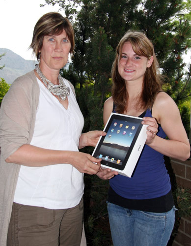 Arlene Olynyk, TRU Alumni Officer, presents Erin her prize, a new Apple iPad