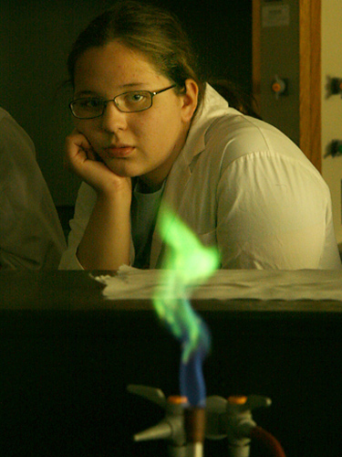 Kayla, from Kamloops,  is absorbed by the demonstration showing the principle behind fireworks. Students were shown how a flame displays a different colour depending on the metal compound sprayed into the flame. In this case, copper was the compound.