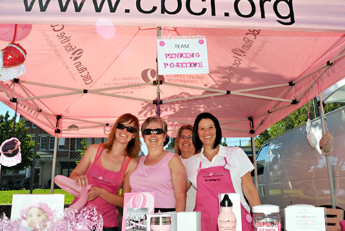 TRU www.tru.ca staff members and four of the 15 members of team Pinking Positive stand still for a moment during what was a busy day of fundraising while at the Kamloops Farmers Market on Aug. 14, 2010. Pinking Positive was raising money towards its participation in the 2010 CIBC Run for the Cure on Oct. 3. Saturday's efforts generated $442, bringing the team's total to $2,179 and in doing so, surpassing the original team goal of $2,000. Pictured is: Jennifer Billingsley (left, with balloon), Goldie Preziosi (beside Jennifer and wearing sunglasses), Kim Eichhorn (in back), and Pamela MacIntosh-Snell (black hair, apron). For more information on the team and its efforts, contact Pamela at pmacintoshsnell@tru.ca 