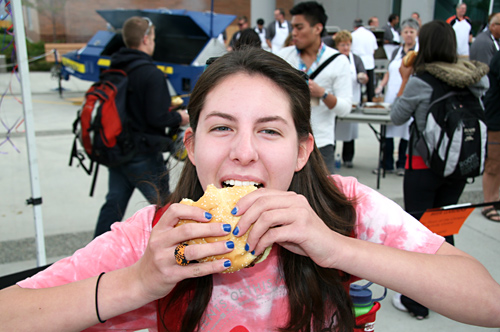 Alix Turk dives into a hamburger during the Back to School BBQ on Friday, Sept. 10. 