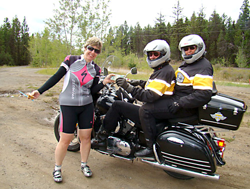 Ride coordinator Maryanne Bower receives some cash from two passersby.