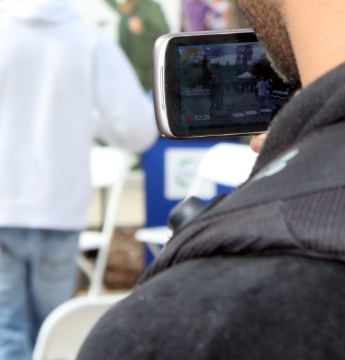 An onlooker records the events. 