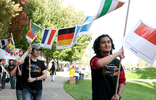 Students carry flags representing the more than 70 different countries represented at TRU this Fall. 