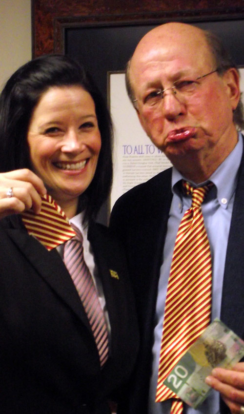 Roger Barnsley, TRU President and Vice Chancellor, pouts as Pamela MacIntosh-Snell of Human Resources removes a piece of his tie.
