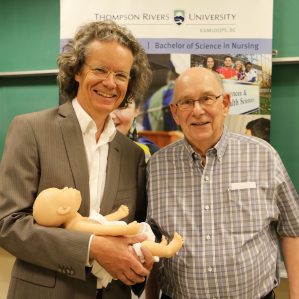 President Alan Shaver with Ken Lepin and baby Florence at the School of Nursing's live birthing demo. 