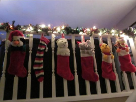 The Avila Family festive stocking arrangement (Jordan's is the Pooh Bear stocking).