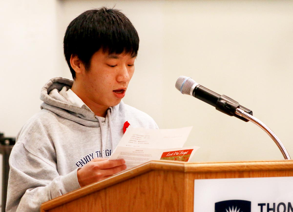 Master of Education student Paul Hu reads the poem In Flanders Fields. 