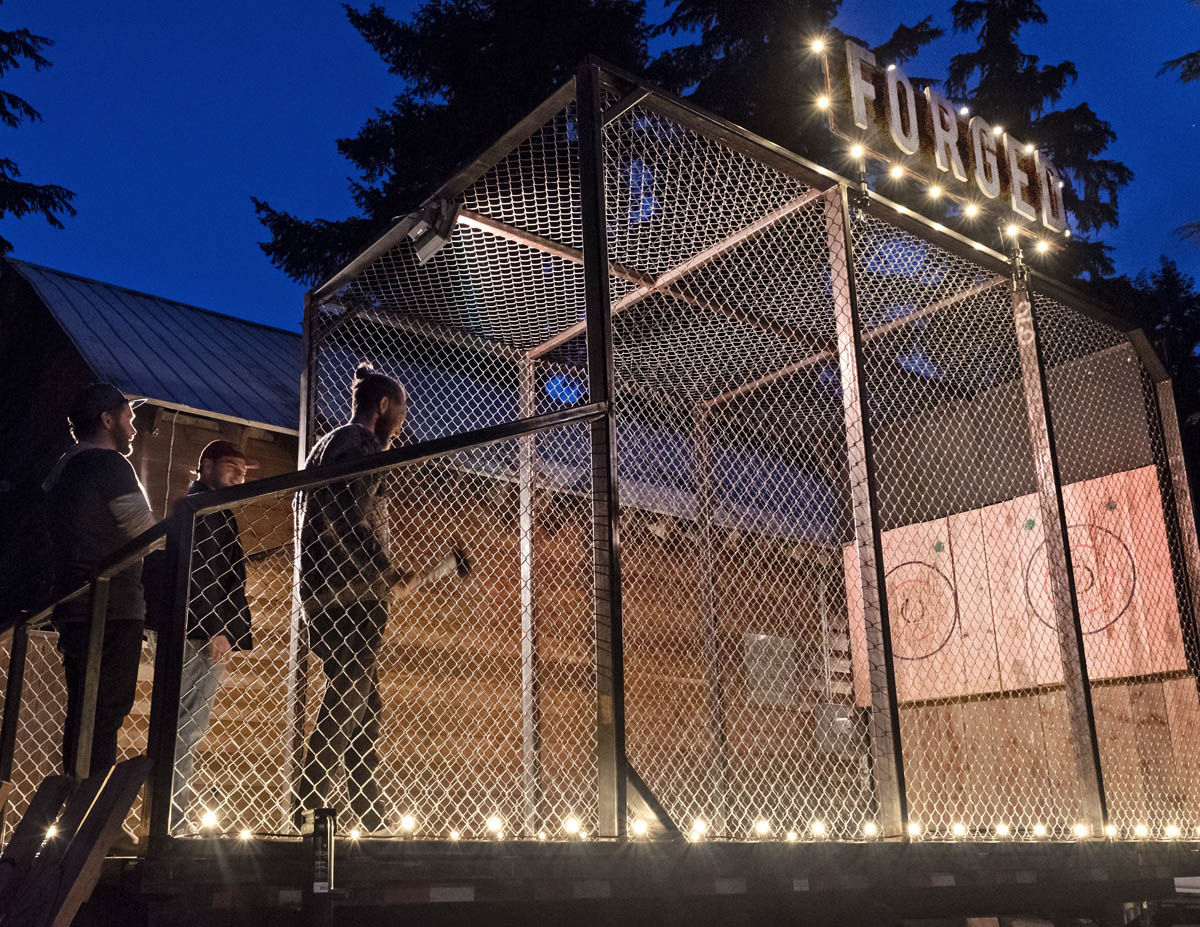 Forged Axe Throwing mobile cage lit at night