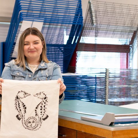 Kiera Duffy with her design screen printed on a canvas tote bag.