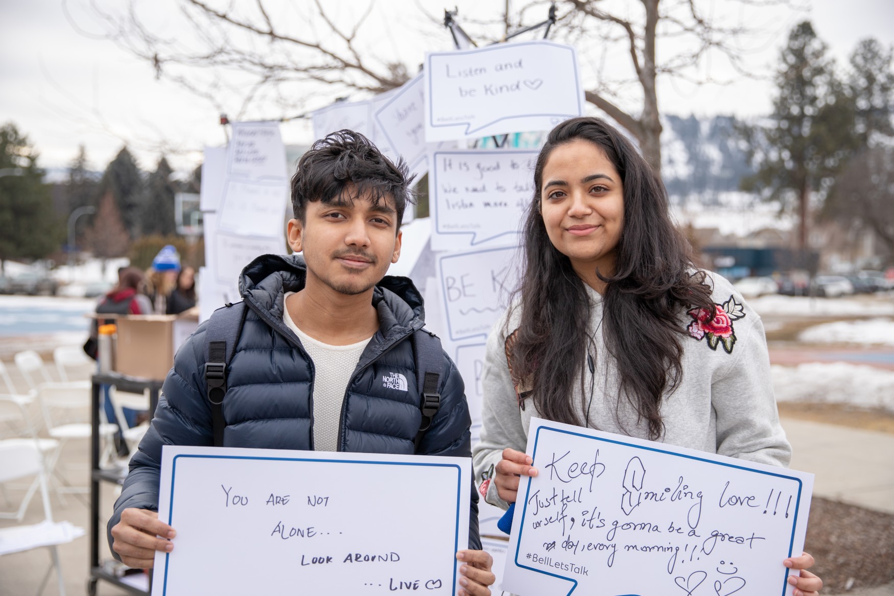 students pose with mental health awarenss signs
