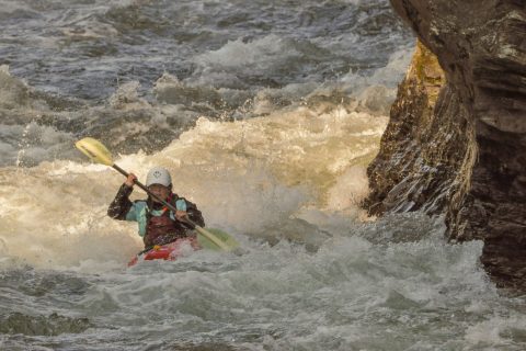 Kayaker paddling in white water