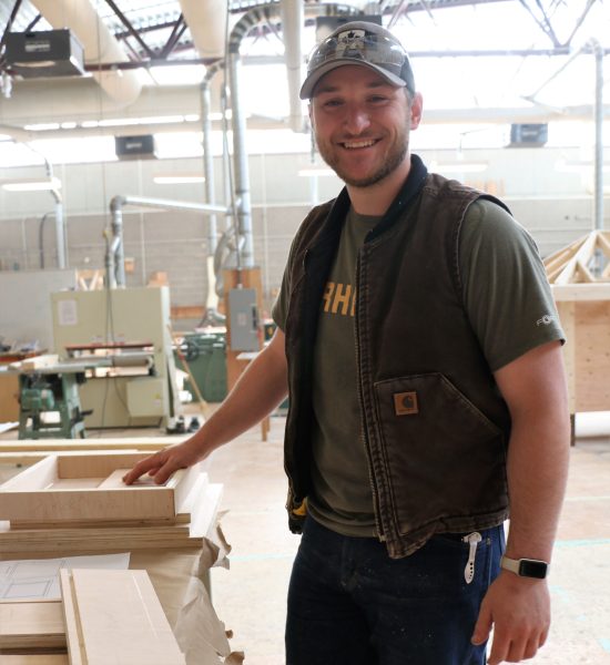 man in a workshop smiling
