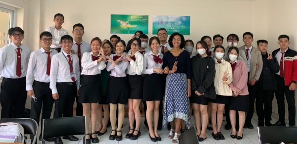 Teacher with a group of students in school uniforms. 