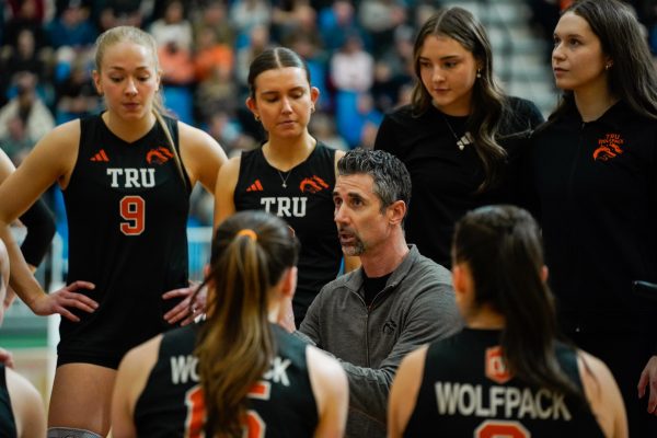 Chad Grimm speaking with players during a game.