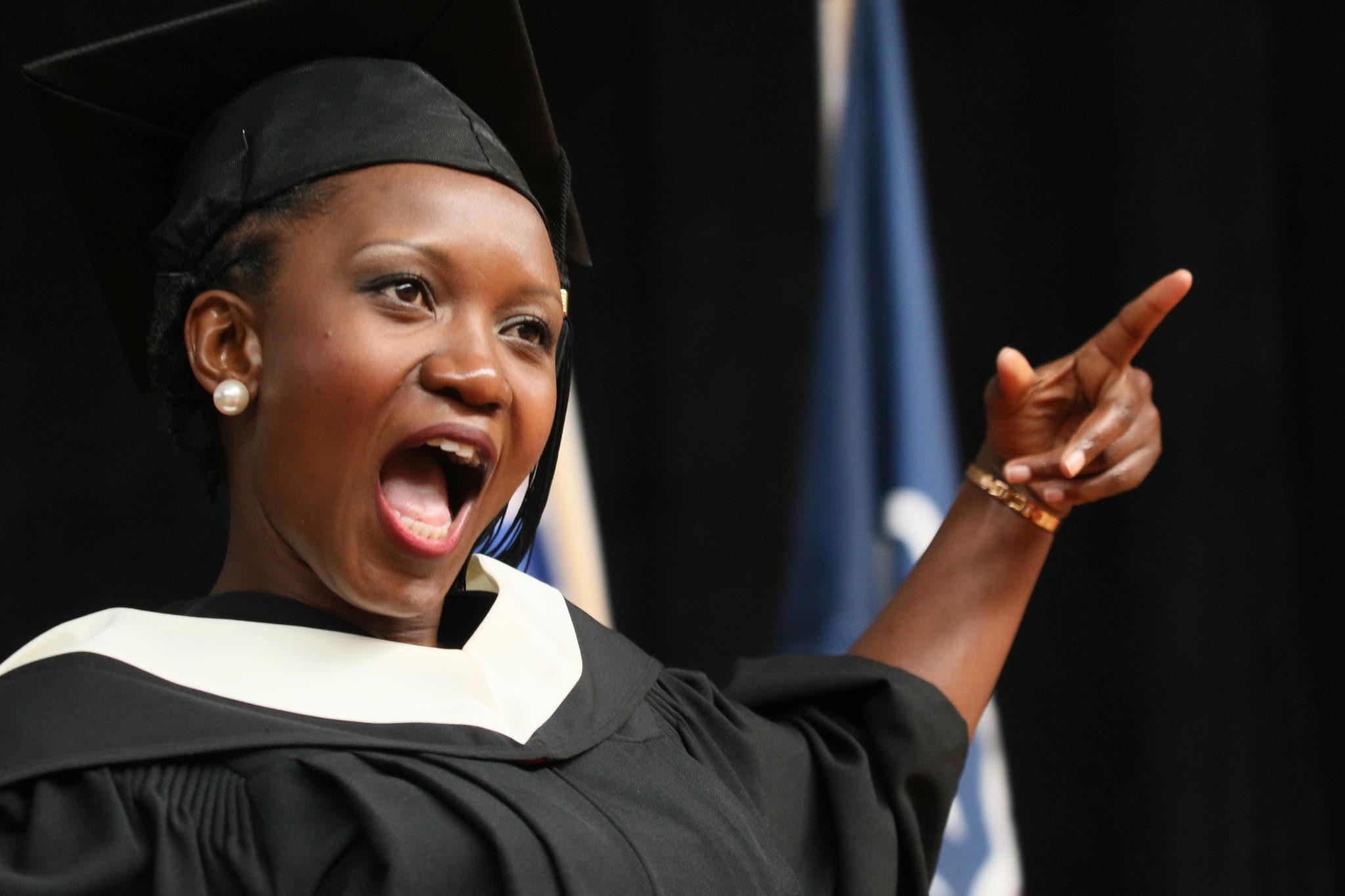 Convocation arts student cheer on stage