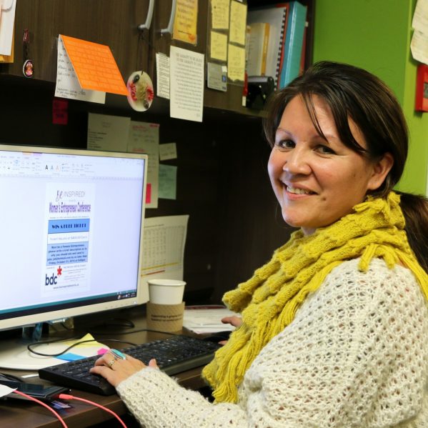 TRU Alumna, Julie John, at her desk, in her store—Eagle Eye—First Nations Gifts