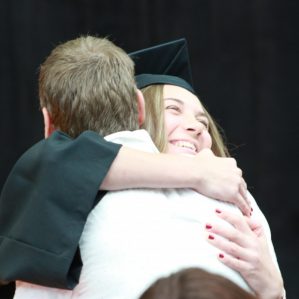 Grad hugs family member