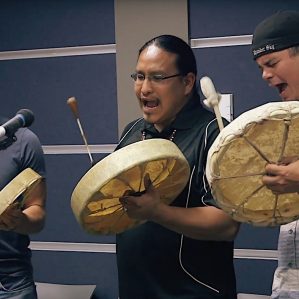 Vernie Clement, (centre) Indigenous mentor and community coordinator, drumming with students Ryan Oliverius (left) and Justin Young