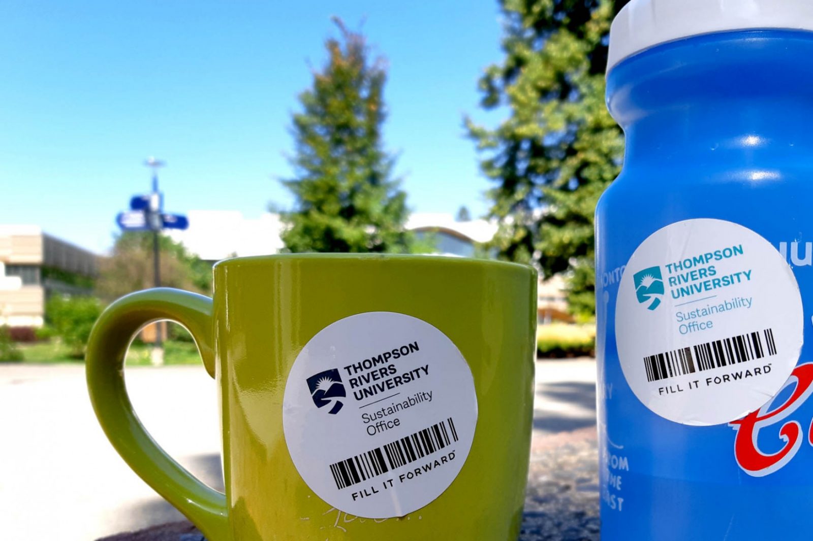 Mug and bottle with Fill It Forward stickers