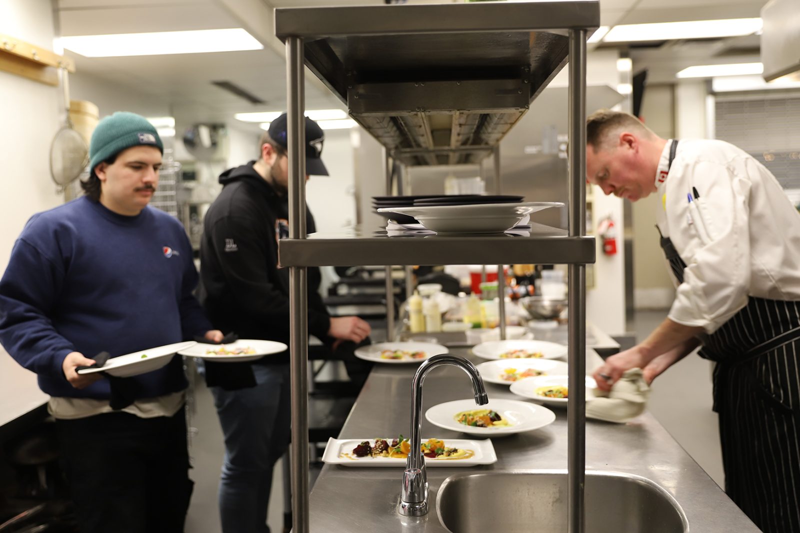 Chef Jared Summers and two students in the Accolades kitchen.