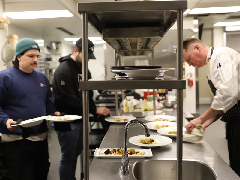 Chef Jared Summers and two students in the Accolades kitchen.