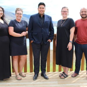 A group of professionals standing outside posing.