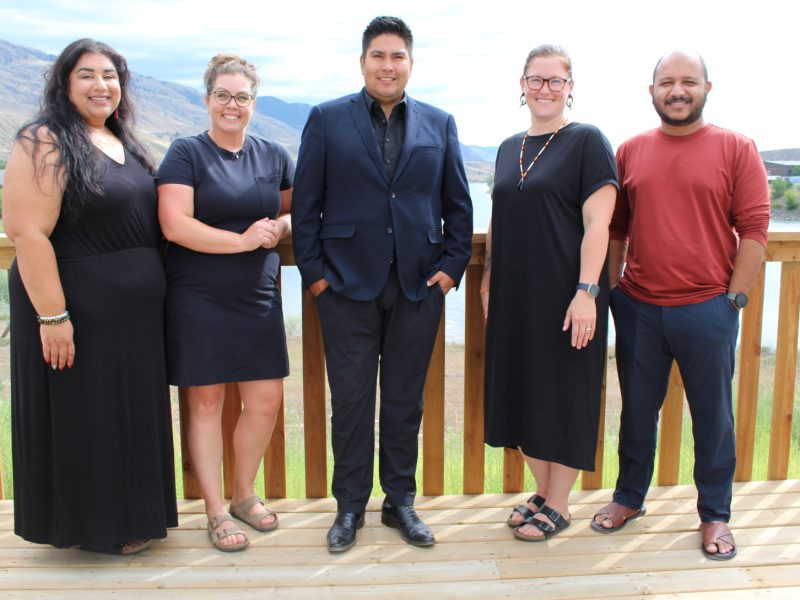 A group of professionals standing outside posing.
