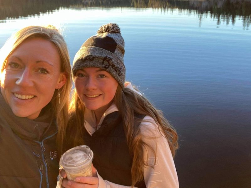 Carmen and Alexis Fenrich take a selfie by a lake.